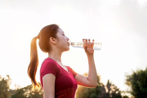 Woman drinking bottle of water